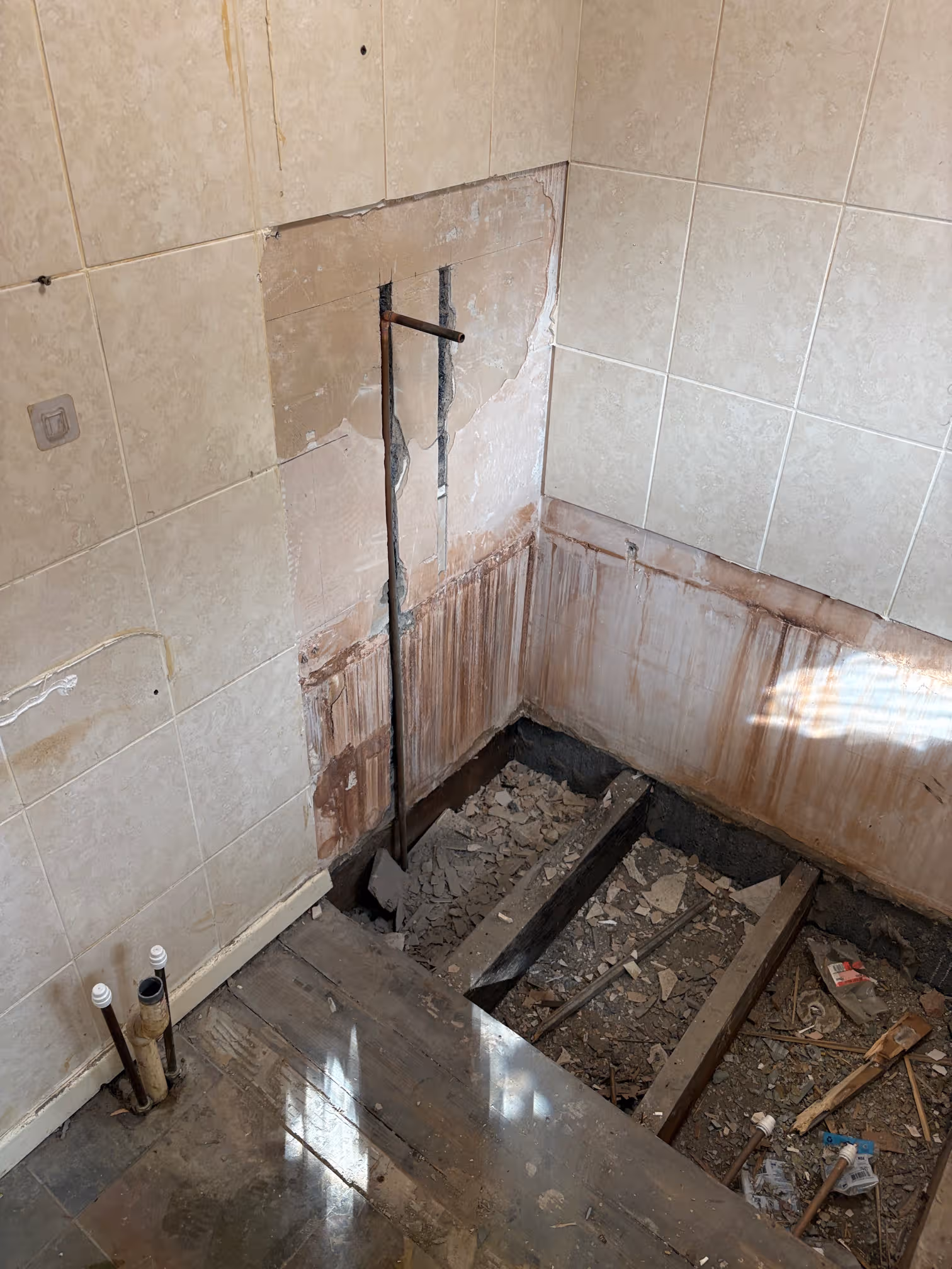 Newcastle bathroom stripped out with the old floor removed and joists exposed