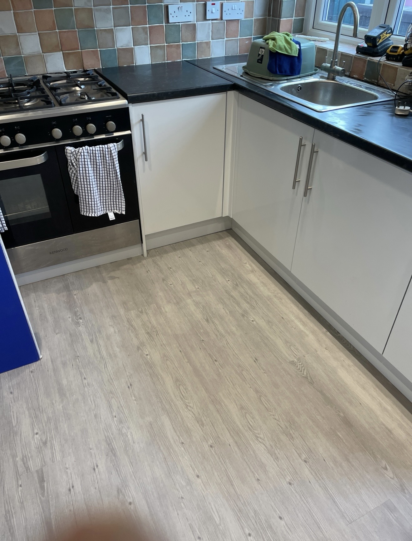 Completed Newcastle kitchen with new units, worktops, sink and wood-effect flooring
