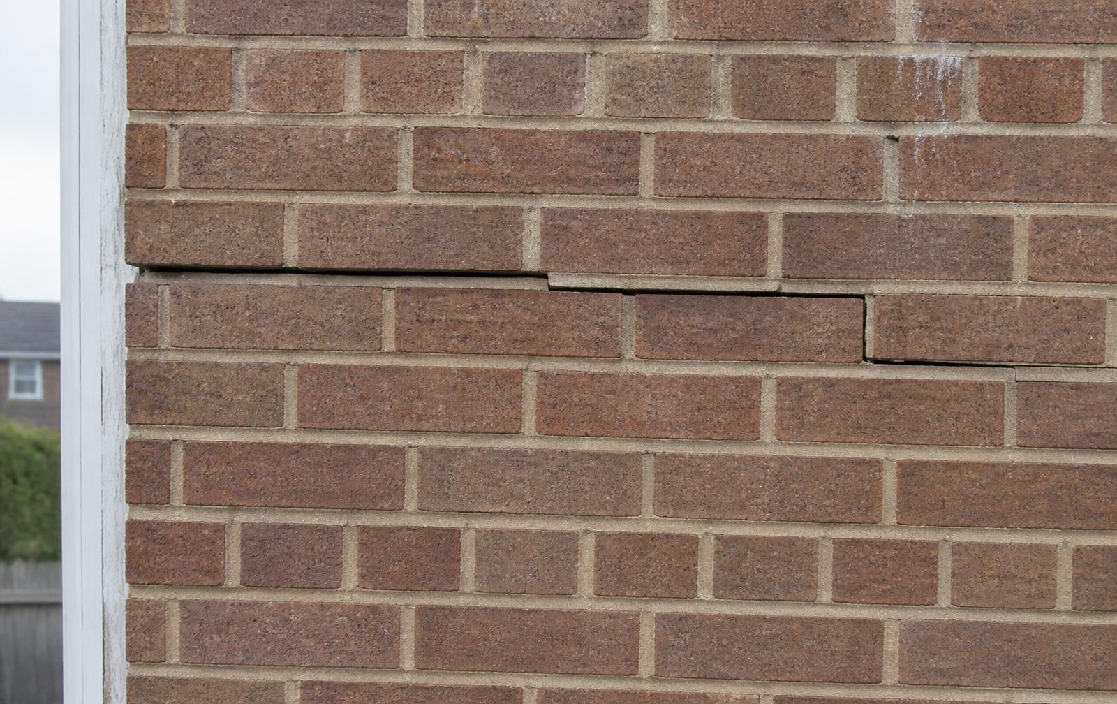 Horizontal cracking along a mortar course in brickwork caused by corroded cavity wall ties